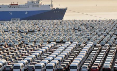 Chinese cars wait for export at a port in Dalian
