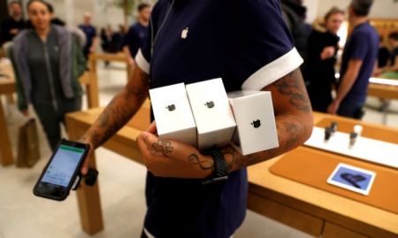 FILE PHOTO: An Apple Store staff shows Apple's new iPhones X after they go on sale at the Apple Store in Regents Street London