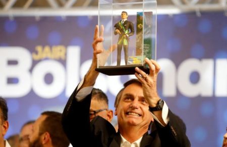 FILE PHOTO: Federal deputy Jair Bolsonaro, a pre-candidate for Brazil's presidential elections, shows a doll of himself during a rally in Curitiba